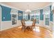 Bright dining room with hardwood floors, chandelier, and blue accent wall at 250 Blackberry Ln, Douglasville, GA 30134