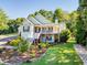 Beautiful two-story home with a welcoming porch, manicured landscaping, and a lush green lawn at 250 Blackberry Ln, Douglasville, GA 30134