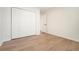 Bright bedroom with wood floors, a closet with bi-fold doors, and neutral walls at 2901 Lenox Ne Rd # 901, Atlanta, GA 30324