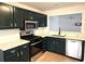 Modern kitchen with stainless steel appliances, stone countertops, and dark cabinets at 2901 Lenox Ne Rd # 901, Atlanta, GA 30324