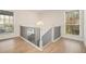 Well-lit staircase with white railings and black spindles, flanked by windows at 2901 Lenox Ne Rd # 901, Atlanta, GA 30324