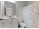 Modern bathroom featuring a polka dot shower curtain, white vanity, and neutral wall color at 133 Bastian Rd, Mcdonough, GA 30252