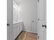 Bright bathroom featuring a double vanity with white cabinets and a decorative rug on wood-look flooring at 133 Bastian Rd, Mcdonough, GA 30252