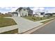 View of the home, driveway and manicured lawn, highlighting the property's curb appeal and spacious surroundings at 133 Bastian Rd, Mcdonough, GA 30252
