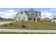 Charming two-story home featuring a combination of painted brick and stone facade with a well-manicured lawn at 133 Bastian Rd, Mcdonough, GA 30252