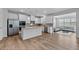 Bright, open kitchen featuring white cabinets, stainless steel appliances, and a granite countertop island at 133 Bastian Rd, Mcdonough, GA 30252