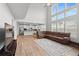 Spacious two-story living room with large windows overlooking the backyard and flowing into the kitchen at 133 Bastian Rd, Mcdonough, GA 30252