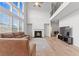 Two-story living room showcasing a fireplace, large windows, and staircase at 133 Bastian Rd, Mcdonough, GA 30252