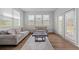 Cozy living room with large windows, a neutral color scheme, and access to an outdoor patio at 133 Bastian Rd, Mcdonough, GA 30252