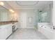 Primary bathroom featuring double sinks, granite countertops, a shower, and a tub at 2296 Valley Brook Ne Way, Atlanta, GA 30319