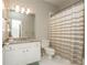 Bathroom with a vanity, a mirror, a toilet, and a shower with a striped curtain at 2296 Valley Brook Ne Way, Atlanta, GA 30319