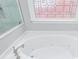 Close-up of bathroom features a jacuzzi tub with jets, a stylish faucet, and tiled walls at 2296 Valley Brook Ne Way, Atlanta, GA 30319