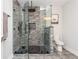 Updated bathroom featuring a glass-enclosed shower with dark hex tile and a modern toilet at 2296 Valley Brook Ne Way, Atlanta, GA 30319