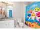 Bathroom with a vanity, a mirror, a toilet, and a shower with a fun 'Baby Shark' curtain at 2296 Valley Brook Ne Way, Atlanta, GA 30319
