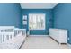 Bright bedroom features modern white furniture, a crib, and a large window with blinds at 2296 Valley Brook Ne Way, Atlanta, GA 30319