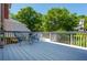 Back deck with blue chairs and small table in the background, surrounded by lush trees at 2296 Valley Brook Ne Way, Atlanta, GA 30319