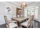 Elegant dining room featuring a dining table, a modern chandelier, and large windows at 2296 Valley Brook Ne Way, Atlanta, GA 30319