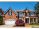 Beautiful brick home featuring a two-car garage, black shutters, and manicured front yard at 2296 Valley Brook Ne Way, Atlanta, GA 30319