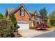 Elegant two-story brick home with an attached garage and well-manicured landscaping at 2296 Valley Brook Ne Way, Atlanta, GA 30319