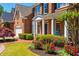 Stunning brick home showcasing a lush front yard with colorful flowers and a welcoming porch at 2296 Valley Brook Ne Way, Atlanta, GA 30319