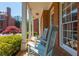 Inviting front porch with blue rocking chairs and views of the beautifully landscaped yard at 2296 Valley Brook Ne Way, Atlanta, GA 30319