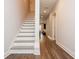 Hallway with hardwood floors, staircase, recessed lighting, and neutral paint at 2296 Valley Brook Ne Way, Atlanta, GA 30319