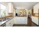 Bright, open kitchen with white cabinets, granite countertops, stainless steel appliances, and hardwood floors at 2296 Valley Brook Ne Way, Atlanta, GA 30319