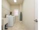 Functional laundry room equipped with a washer, dryer, and utility sink at 2296 Valley Brook Ne Way, Atlanta, GA 30319