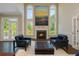 Comfortable living room with fireplace, two chairs, ottoman and large windows with a scenic view at 2296 Valley Brook Ne Way, Atlanta, GA 30319