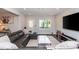 Modern living room with a gray leather sofa, a large TV, and neutral walls at 2296 Valley Brook Ne Way, Atlanta, GA 30319