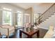 Bright living room with large windows, staircase, and comfortable seating area at 2296 Valley Brook Ne Way, Atlanta, GA 30319