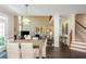 Open-concept design with dining area flowing into a living space with a fireplace and staircase at 2296 Valley Brook Ne Way, Atlanta, GA 30319