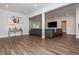Spacious open floor plan featuring wood floors, recessed lighting, and a large grey sofa at 2296 Valley Brook Ne Way, Atlanta, GA 30319