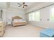 A spacious main bedroom featuring a tray ceiling, a large window, and neutral carpet flooring at 2296 Valley Brook Ne Way, Atlanta, GA 30319