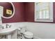 A charming powder room with a pedestal sink, updated fixtures, and decorative wainscoting at 2296 Valley Brook Ne Way, Atlanta, GA 30319