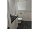 Bathroom showcasing a dark vanity, a modern toilet, and a large window at 305 Henry Aaron Sw Ave, Atlanta, GA 30310