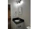 Bathroom vanity with dark countertop, undermount sink, and modern lighting at 305 Henry Aaron Sw Ave, Atlanta, GA 30310
