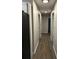 Hallway with neutral wall paint and dark wood look flooring at 305 Henry Aaron Sw Ave, Atlanta, GA 30310