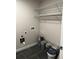 Laundry room area with tiled floor, wire shelves, and hookups at 305 Henry Aaron Sw Ave, Atlanta, GA 30310