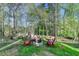 Cozy backyard fire pit area with comfortable Adirondack chairs and a tranquil wooded backdrop at 4230 Braden Nw Ln, Kennesaw, GA 30144