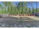 Lush backyard with mature trees, tidy landscaping, and a wood fence providing privacy at 4230 Braden Nw Ln, Kennesaw, GA 30144