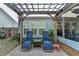 Serene backyard patio with brick pavers, comfortable lounge chairs, and wooden pergola for outdoor relaxation at 4230 Braden Nw Ln, Kennesaw, GA 30144