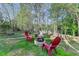 Backyard with outdoor seating area featuring a fire pit and Adirondack chairs for relaxing evenings at 4230 Braden Nw Ln, Kennesaw, GA 30144