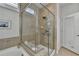 Bathroom featuring a glass-enclosed shower with safety bars and a jacuzzi tub at 4230 Braden Nw Ln, Kennesaw, GA 30144
