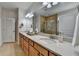 Bathroom featuring a double sink vanity, large mirror, and tiled shower at 4230 Braden Nw Ln, Kennesaw, GA 30144