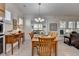 Bright dining room features a wooden table set, decorative chandelier, and adjacent living space at 4230 Braden Nw Ln, Kennesaw, GA 30144