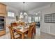 Bright dining room with wood floors, crown molding, and a view of the living room at 4230 Braden Nw Ln, Kennesaw, GA 30144
