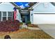 Inviting front entrance with a charming door, American flag, and beautiful landscaping at 4230 Braden Nw Ln, Kennesaw, GA 30144
