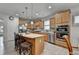 Stylish kitchen with wood cabinets, stainless steel appliances, an island with barstools and quartz countertops at 4230 Braden Nw Ln, Kennesaw, GA 30144