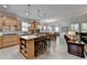 Open kitchen with a central island, wooden cabinets, and seamless flow into the dining area at 4230 Braden Nw Ln, Kennesaw, GA 30144